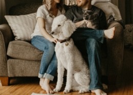 Coppia italiana seduta sul divano con il loro cane, esempio di animali domestici come membri della famiglia